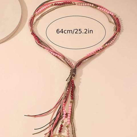 Long necklace with leather straps, beads and pendants