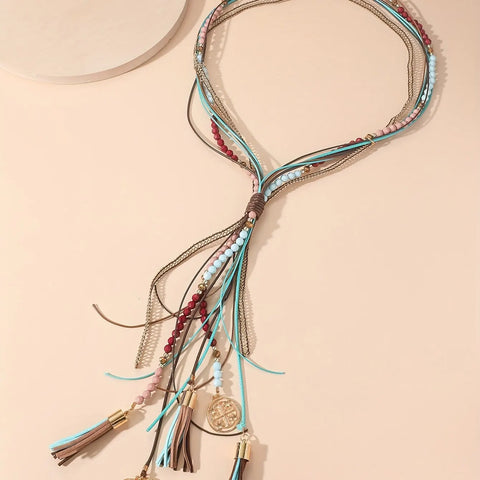 Long necklace with leather straps, beads and pendants