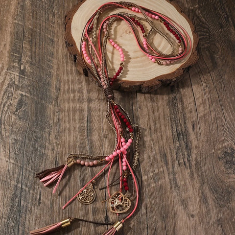 Long necklace with leather straps, beads and pendants