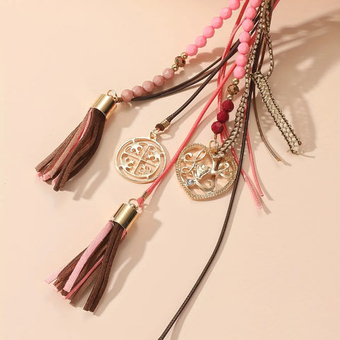 Long necklace with leather straps, beads and pendants